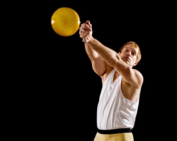 Athlete competing in hammer throw. Studio shot over black. — Stock Photo, Image