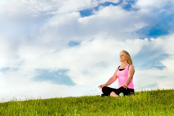 stock image Middle-aged woman in her 40s meditating for exercise outdoors