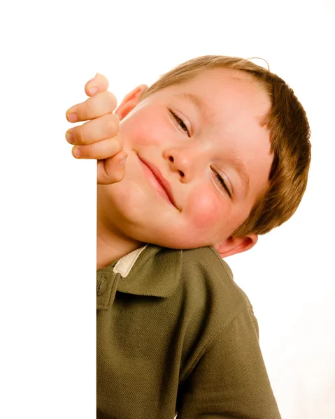 Porträt eines glücklichen kleinen Jungen, der isoliert auf weiß um die Ecke blickt — Stockfoto