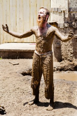 Performer covered in mud at Georgia Renaissance Festival clipart
