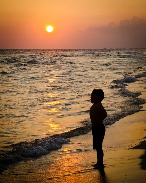 stock image Child playing on beach at sunset