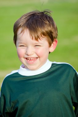 Portrait of happy young boy in soccer uniform