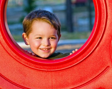 Young boy playing on playground clipart