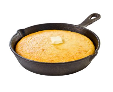 Corn bread in iron skillet isolated on white clipart