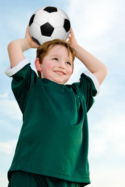 Young boy playing soccer in organized league game — Stock Photo, Image