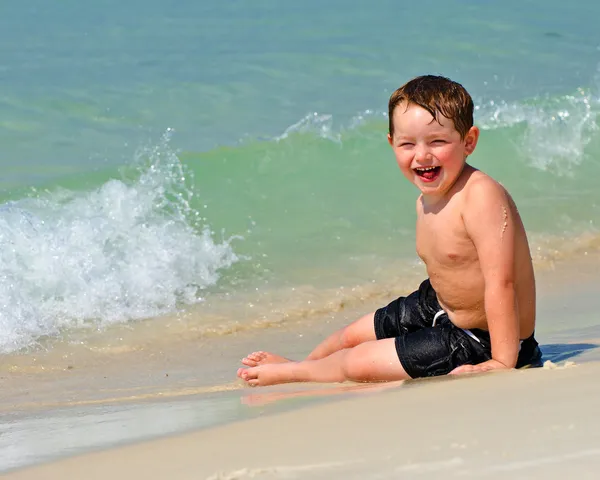 Portrait of young boy playing in surf at beach — Stock Photo, Image