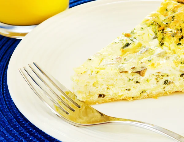 stock image Slice of egg quiche with orange juice served for breakfast