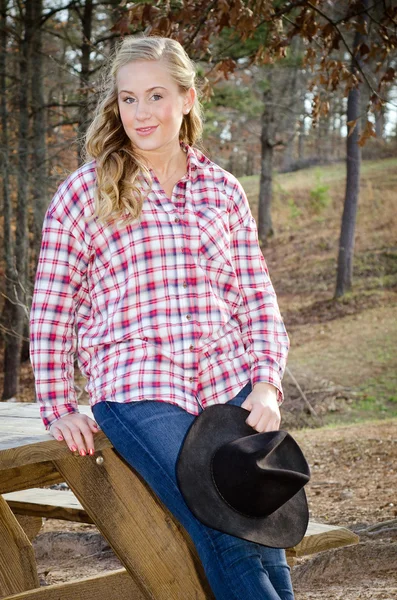 Outdoor portrait of beautiful blonde woman in western clothing Stock Picture