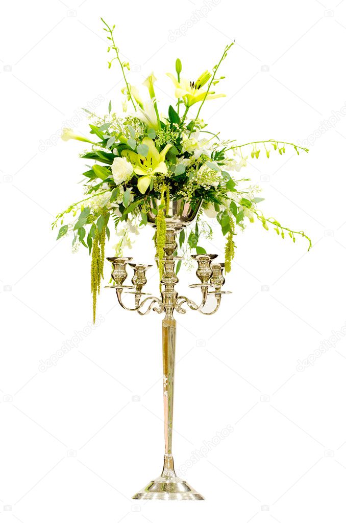 Wedding flower arrangement centerpiece with orchid, rose, lily, calla lily on Victorian candelabra isolated on white