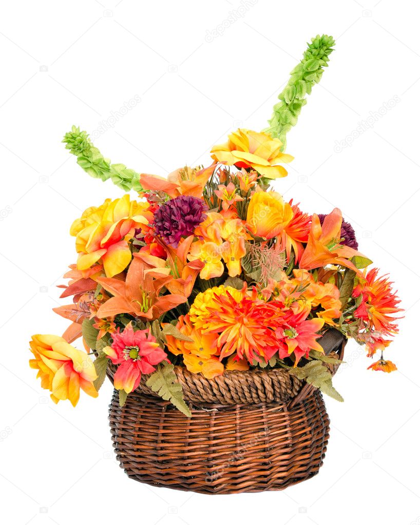 Fall color silk flower arrangement in basket isolated on white