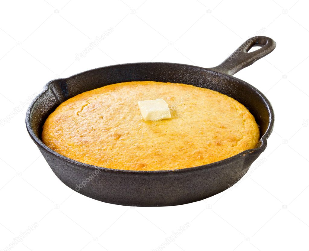Corn bread in iron skillet isolated on white