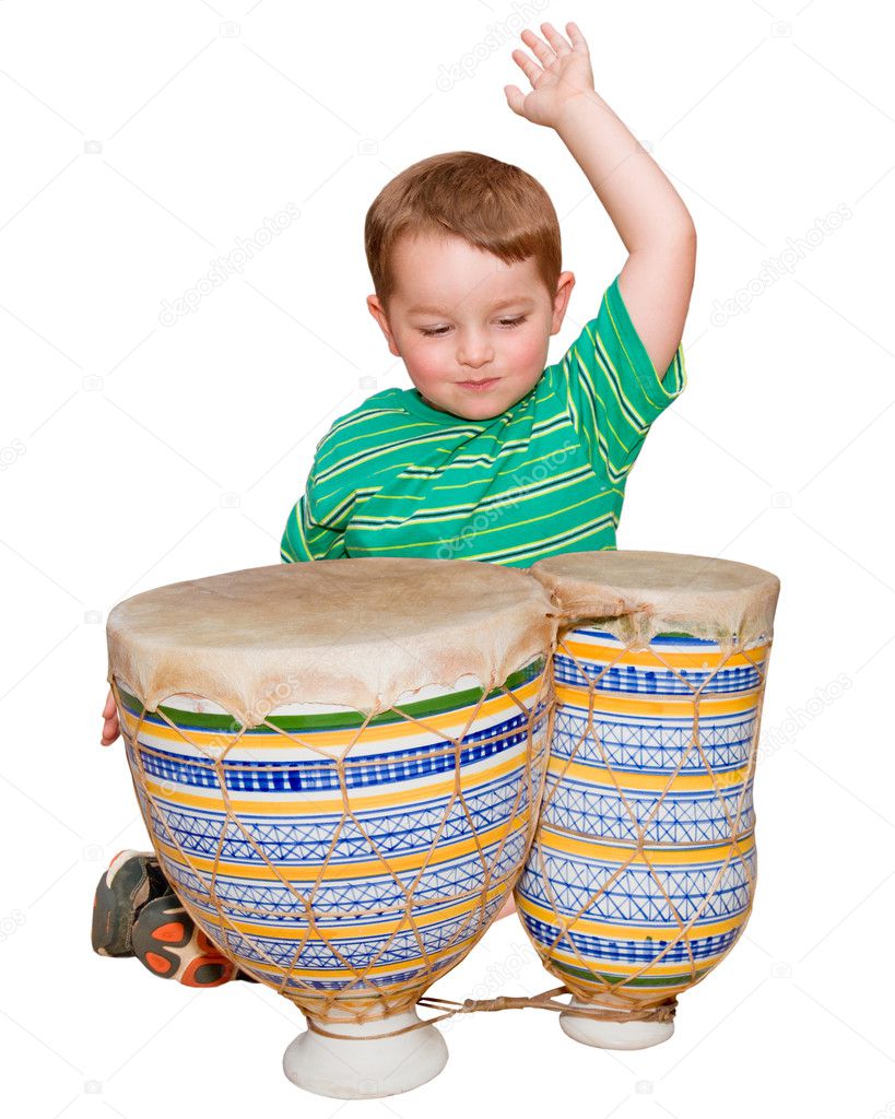 Young boy plays African bongo tom-tom drums, isolated on white background
