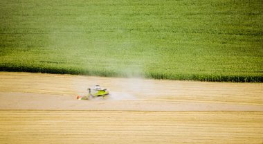 The combine harvester in the field clipart