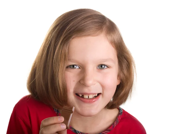 Ευτυχισμένη χαρούμενη κοριτσάκι που τρώει σοκολάτα Royalty Free Εικόνες Αρχείου