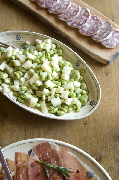 Healthy bean salad and cutting sausage and cured meat — Stock Photo, Image