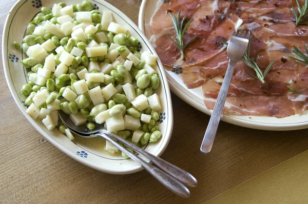 Healthy bean salad and cutting sausage and cured meat — Stock Photo, Image
