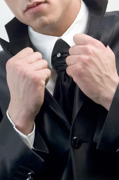 Young handsome businessman in black suit on white. — Stock Photo, Image