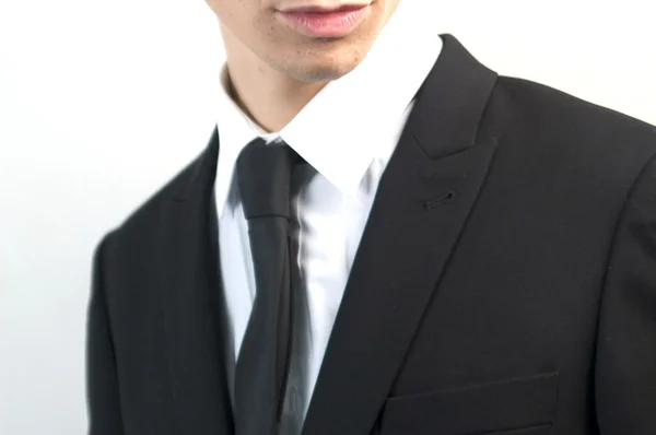 Giovane bell'uomo d'affari in abito nero su bianco . — Foto Stock