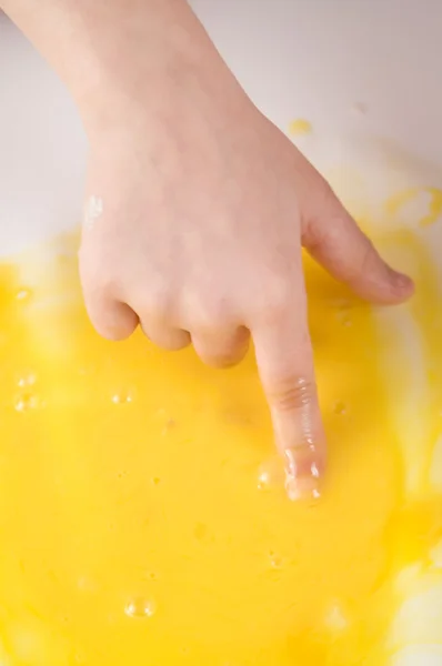 Eggs with children's hand — Stock Photo, Image