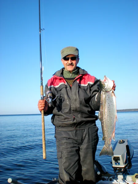 Fisherman holding a big fresh fish