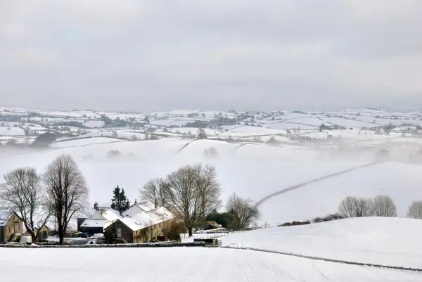 stock image Small Farmhouse in Snow Covered Hills