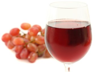 Copa de vino tinto con uva aislado sobre fondo blanco