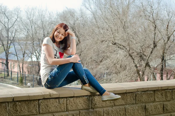 stock image Beautiful girl with brown hair sitting and smiling