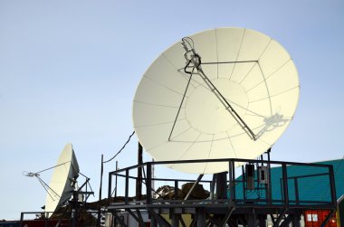 Paraboloid antenna against blue sky clipart