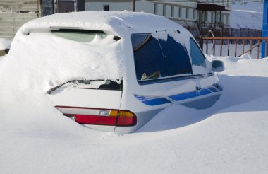 Snow covered car in the snowdrift after cyclone clipart