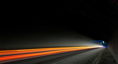 Car light trails in the tunnel clipart