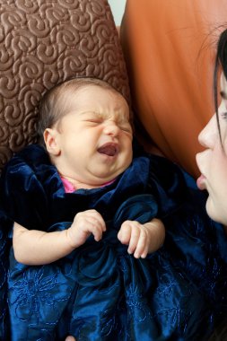 Mother Comforts a Crying Newborn Baby clipart