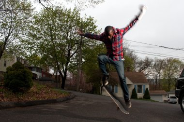 Skateboarder Man Doing an Ollie Jump clipart