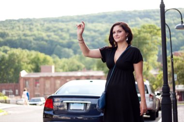 Woman Hailing a Taxi Cab clipart