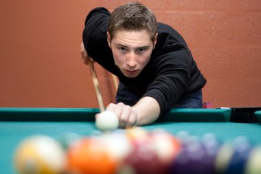 Young Man Shooting Pool clipart