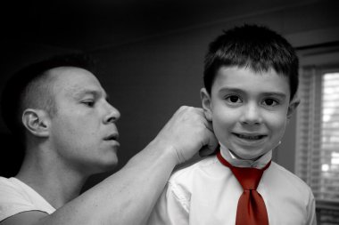 Father Helping Son Get Ready clipart