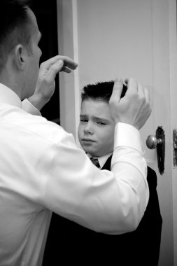 Father Helping Son Get Ready clipart