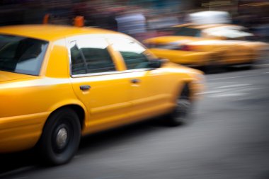 Speeding Yellow Taxi Cabs Motion Blur clipart