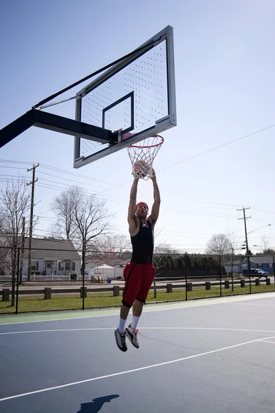 Mann beim Dunking eines Basketballs — Stockfoto