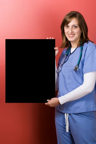 Enfermera feliz con signo — Foto de Stock