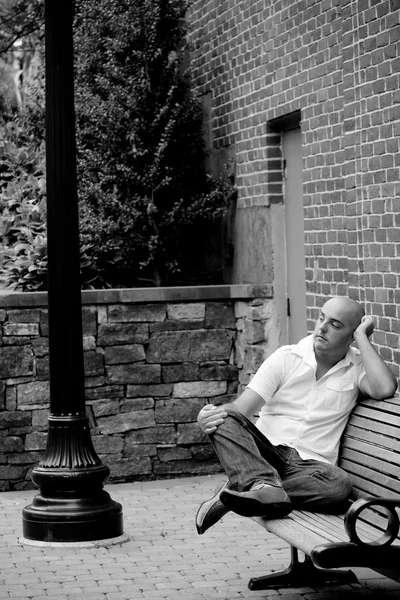 Casual τύπος που κάθεται σε ένα παγκάκι πόλη — Φωτογραφία Αρχείου