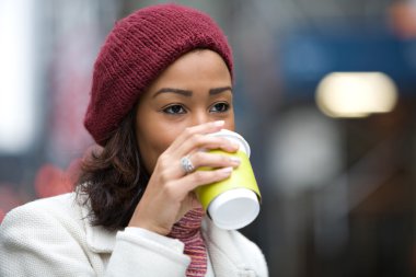 Woman Drinking a Hot Beverage clipart