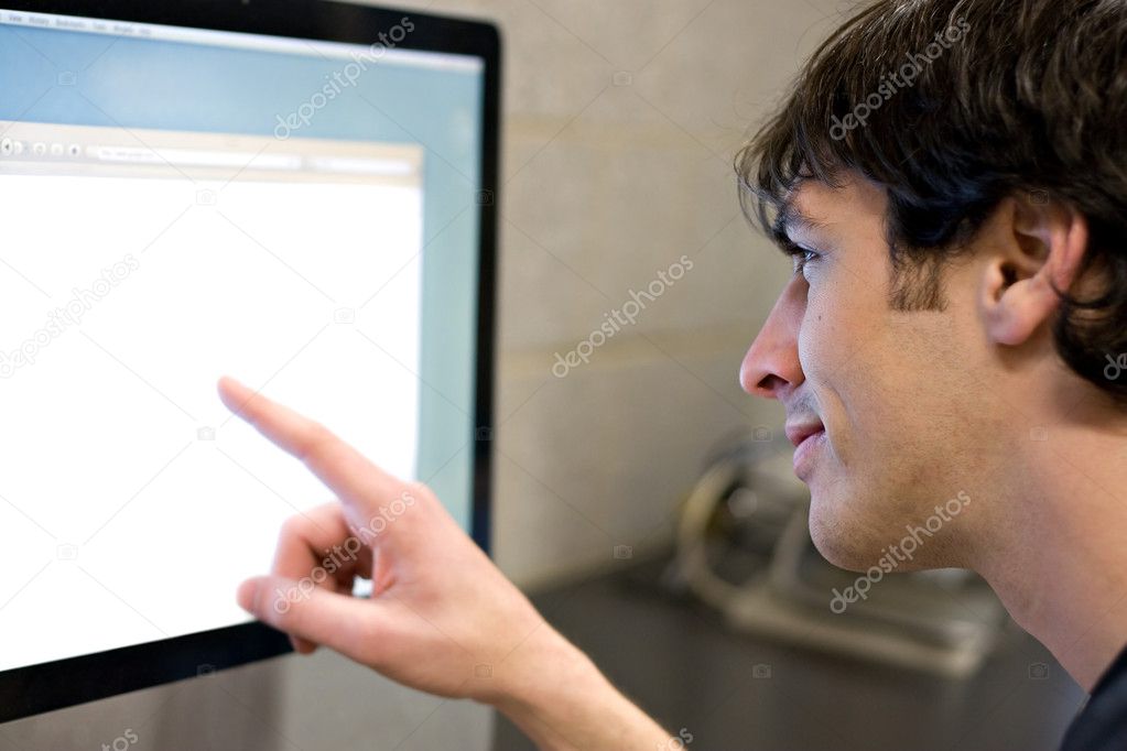 Man Pointing at Computer Screen