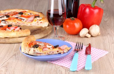 Composition with slice of pizza on plate close-up on wooden background