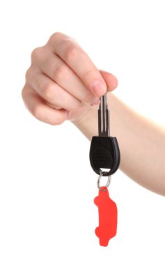 Car key with charm in hand isolated on white clipart