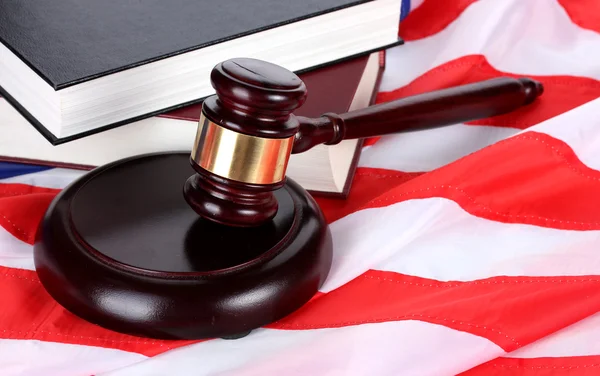 stock image Judge gavel and books on american flag background