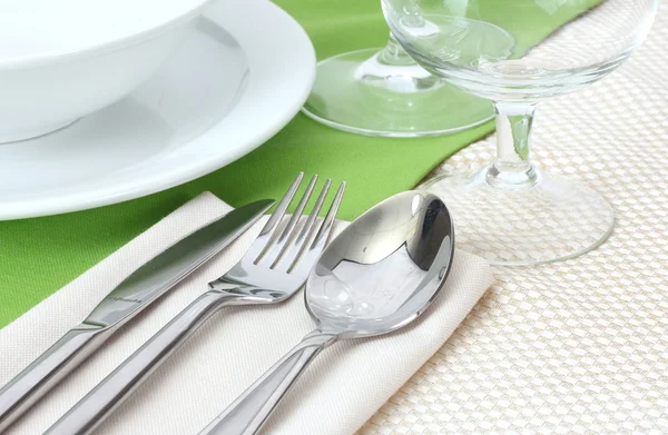 Apparecchiatura della tavola con forchetta, coltello, cucchiaio, piatti e tovagliolo — Foto Stock