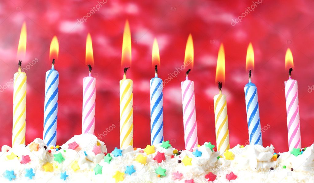 Beautiful birthday candles on red background