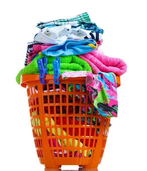 Clothes in orange plastic basket isolated on white — Stock Photo, Image