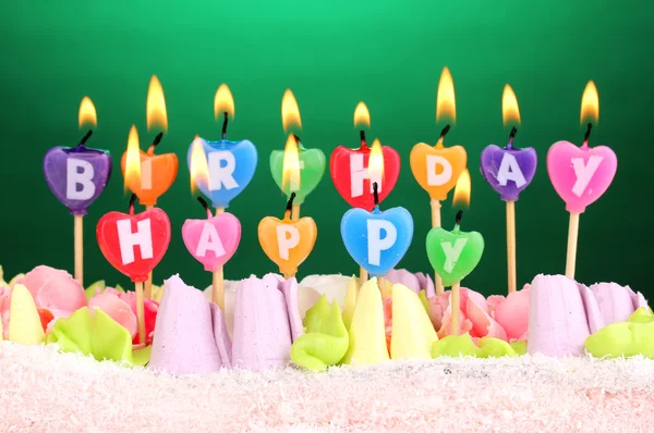 緑色の背景でキャンドルで誕生日ケーキ — ストック写真