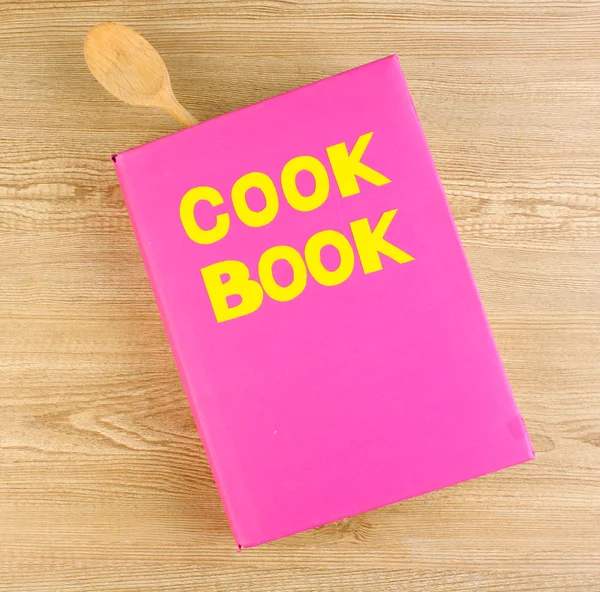 Cookbook and kitchenware on wooden background — Stock Photo, Image